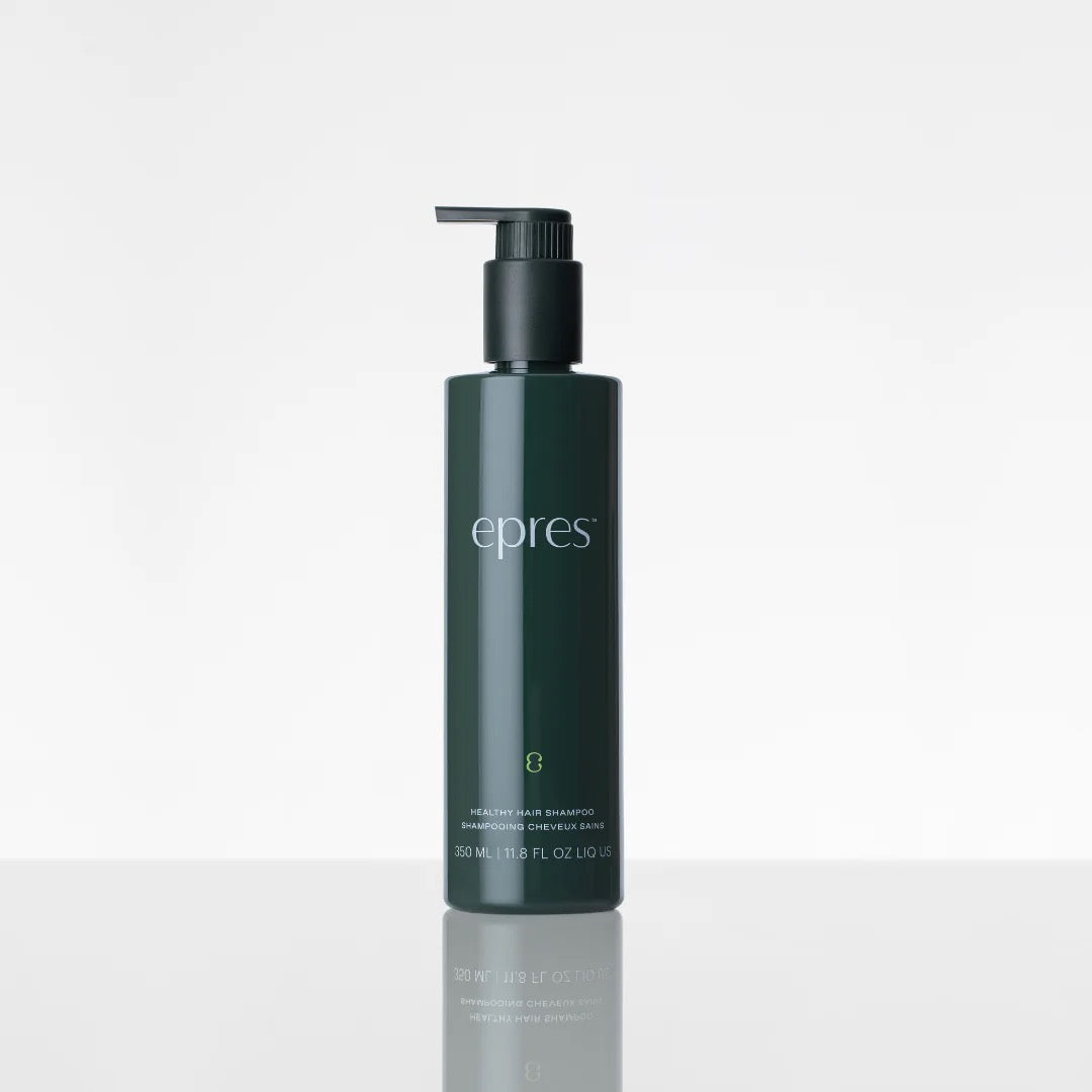 Dark green shampoo bottle with pump labeled 'epres' on a light gray background