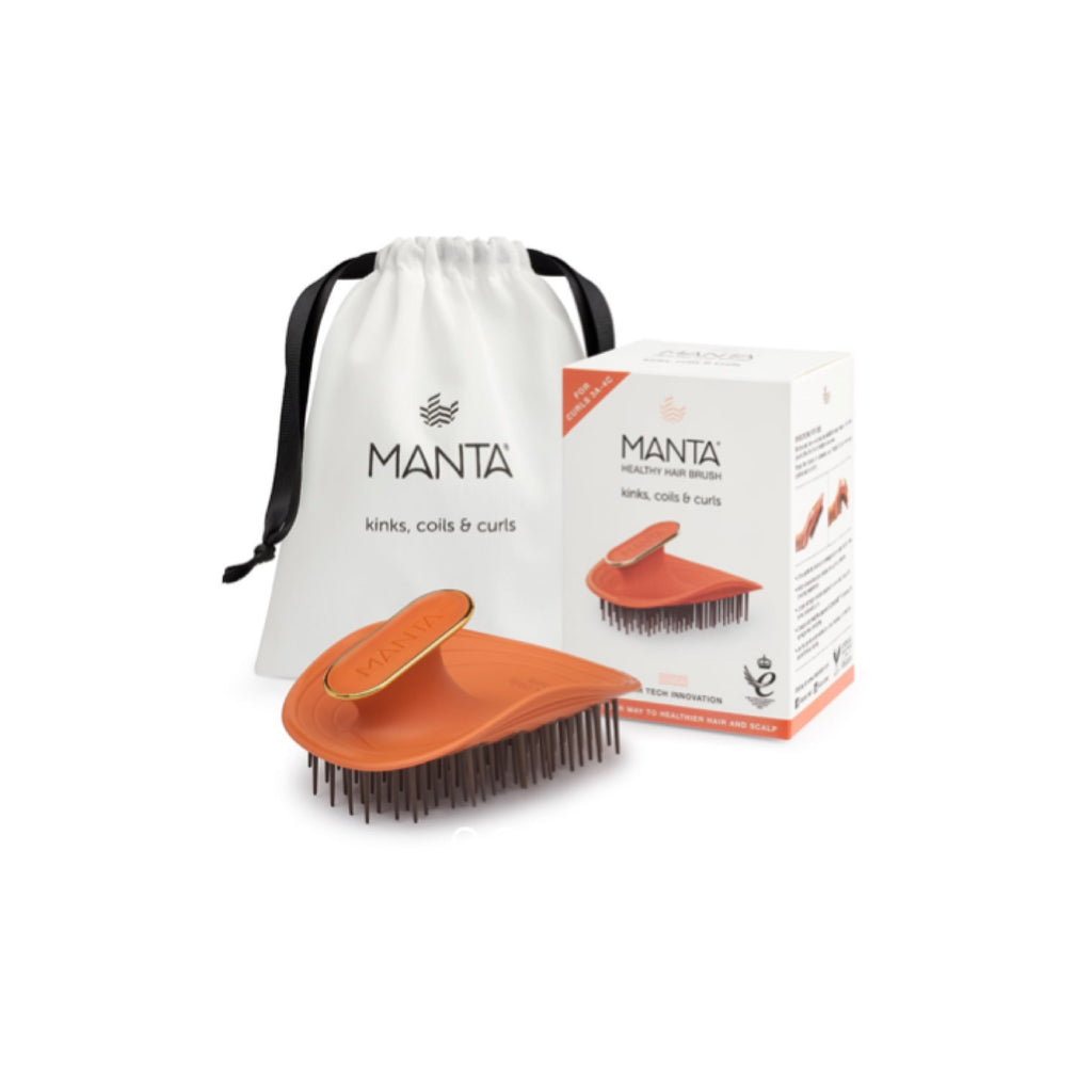 Orange hairbrush with Manta packaging and drawstring bag on a white background