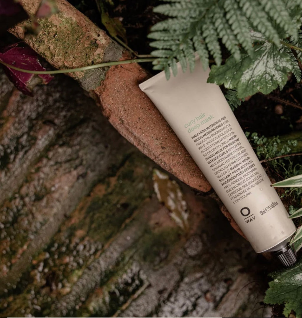 Tube of Oway product on a textured surface with greenery