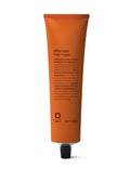 Orange tube of Oway after-sun hair mask on a white background